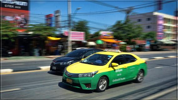 Blurry Green and Yellow Taxi